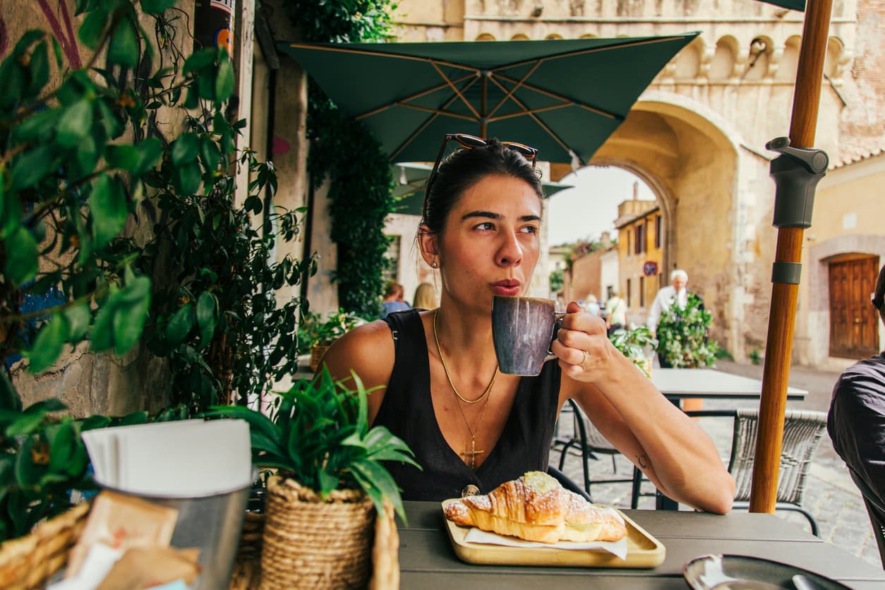 A woman drinking coffee while a coffee tour A woman drinking coffee while a coffee tour